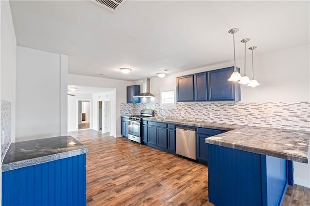2914 Debra, Corpus Christi, TX 78418 - kitchen featuring wall chimney range hood, visible vents, stainless steel appliances, dark countertops, and a peninsula