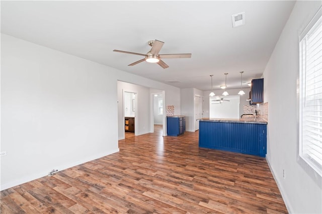 2914 Debra, Corpus Christi, TX 78418 - unfurnished living room featuring wood finished floors, plenty of natural light, a ceiling fan, and visible vents