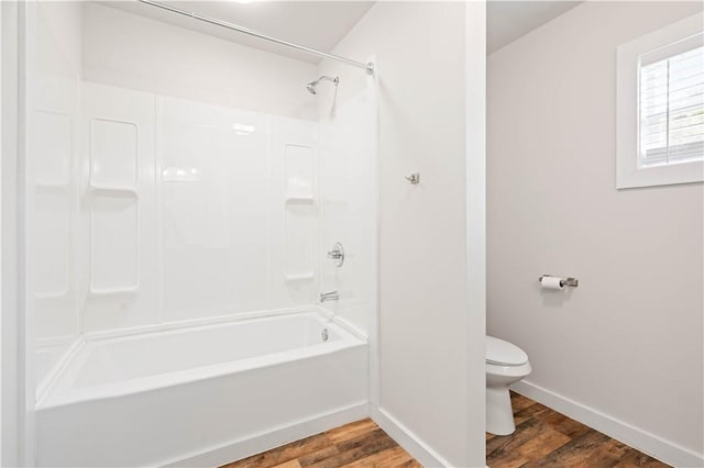 2914 Debra, Corpus Christi, TX 78418 - bathroom with baseboards, wood finished floors, toilet, and  shower combination