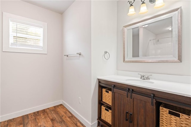 2914 Debra, Corpus Christi, TX 78418 - bathroom with vanity, a chandelier, a shower, baseboards, and wood finished floors