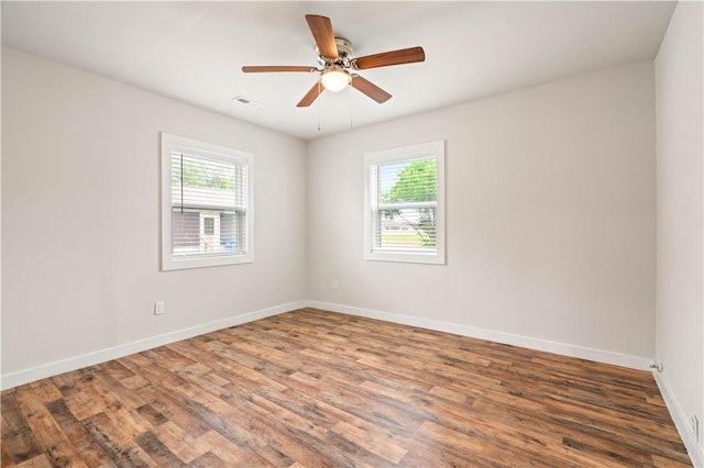 2914 Debra, Corpus Christi, TX 78418 - empty room featuring visible vents, wood finished floors, and a healthy amount of sunlight