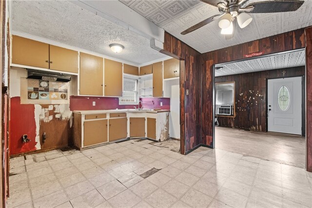 4833 Larcade Dr, Corpus Christi, TX 78415 - kitchen featuring light flooring, wood walls, a ceiling fan, light countertops, and cooling unit