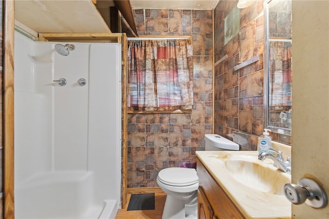 4833 Larcade Dr, Corpus Christi, TX 78415 - full bathroom with a shower stall, vanity, and tile walls