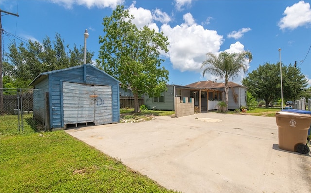 4833 Larcade Dr, Corpus Christi, TX 78415 - view of front of property with a storage shed, a detached garage, and concrete driveway