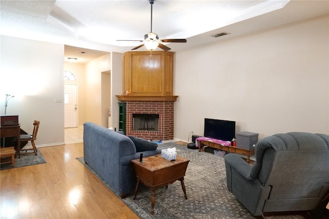 14929 Red River Dr, Corpus Christi, TX 78410 - living room featuring ceiling fan, light wood finished floors, a fireplace, and baseboards