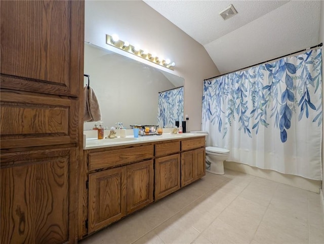 14929 Red River Dr, Corpus Christi, TX 78410 - bathroom with double vanity, lofted ceiling, toilet, and tile patterned floors