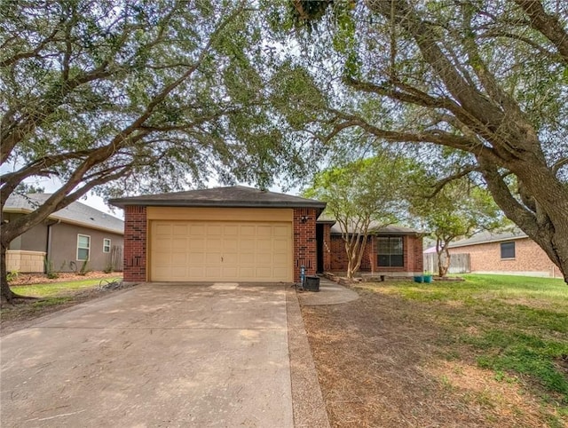 14929 Red River Dr, Corpus Christi, TX 78410 - view of front facade with brick siding, concrete driveway, and a garage