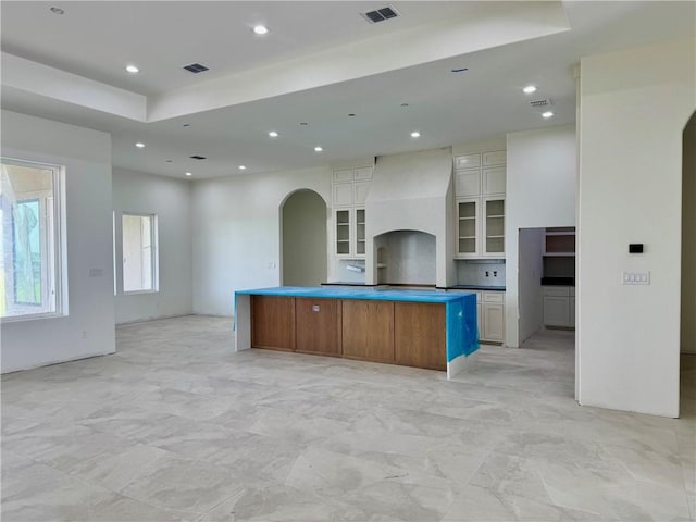 758 Buffalo Creek Dr, Corpus Christi, TX 78415 - kitchen featuring arched walkways, white cabinetry, recessed lighting, open floor plan, and a large island