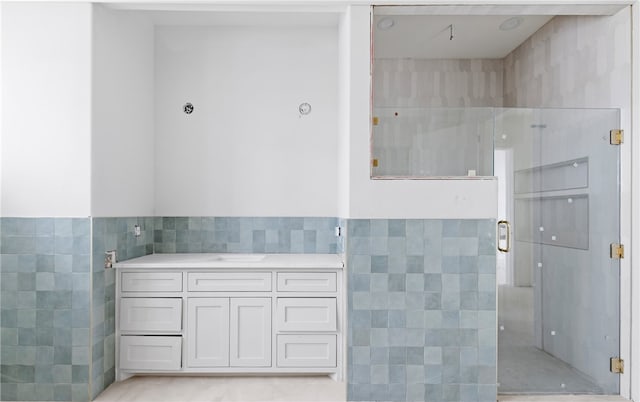 758 Buffalo Creek Dr, Corpus Christi, TX 78415 - bathroom featuring tile walls, a stall shower, and vanity