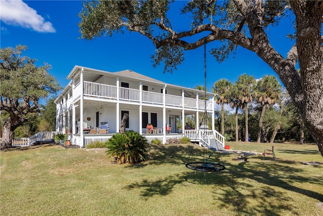 back of property with covered porch, a lawn, and a balcony