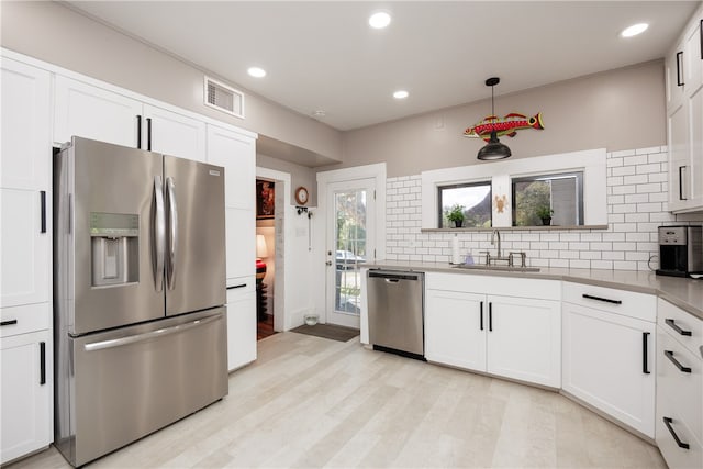 kitchen featuring white cabinetry, stainless steel appliances, and sink