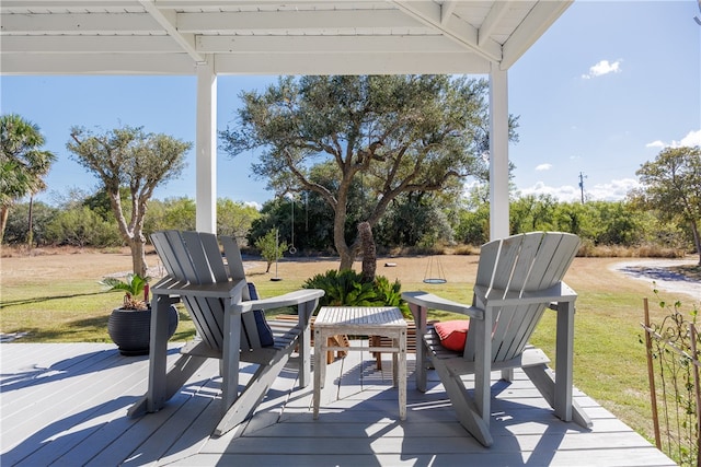 wooden terrace featuring a lawn