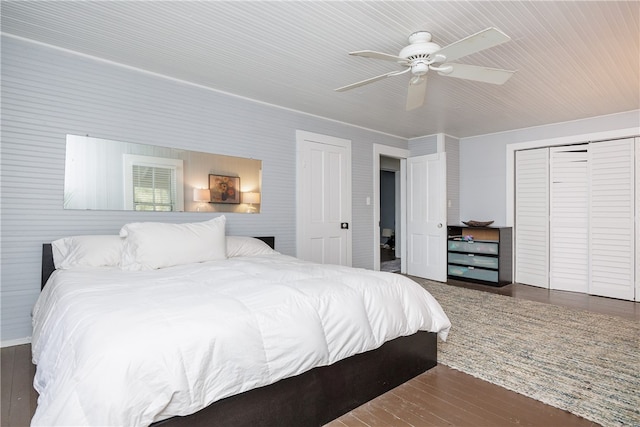 bedroom featuring ceiling fan, a closet, and dark hardwood / wood-style flooring