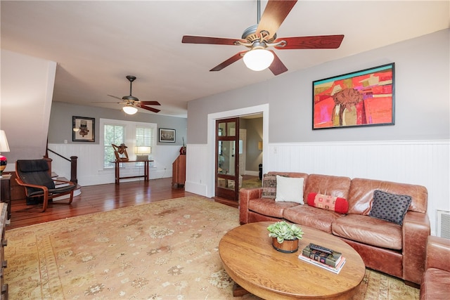 living room with wood-type flooring and ceiling fan