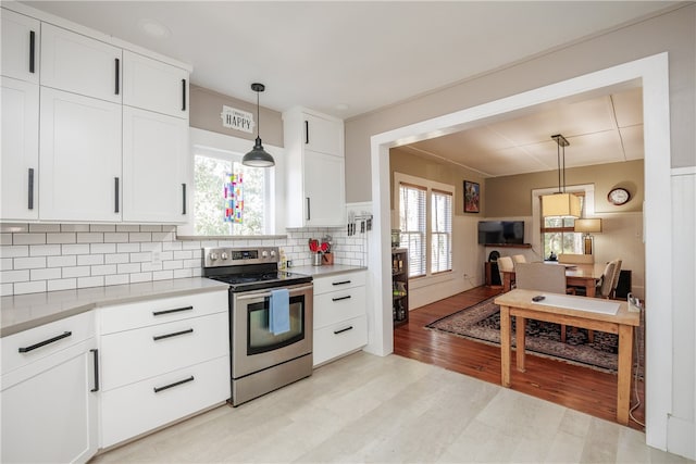 kitchen with white cabinets, light hardwood / wood-style floors, plenty of natural light, and electric stove