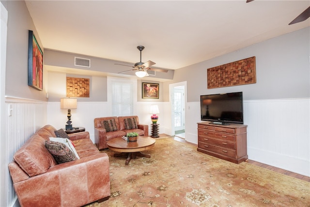 living room with wood-type flooring and ceiling fan