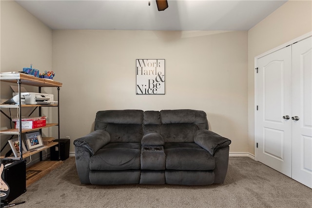 carpeted living room with ceiling fan