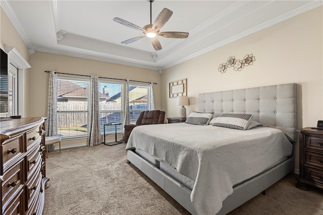 carpeted bedroom featuring a raised ceiling, ceiling fan, and ornamental molding