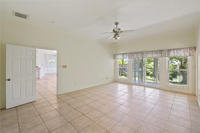 unfurnished room featuring light tile patterned floors, a ceiling fan, a chandelier, and baseboards