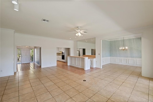 unfurnished living room with a decorative wall, light tile patterned flooring, a chandelier, ceiling fan, and ornamental molding