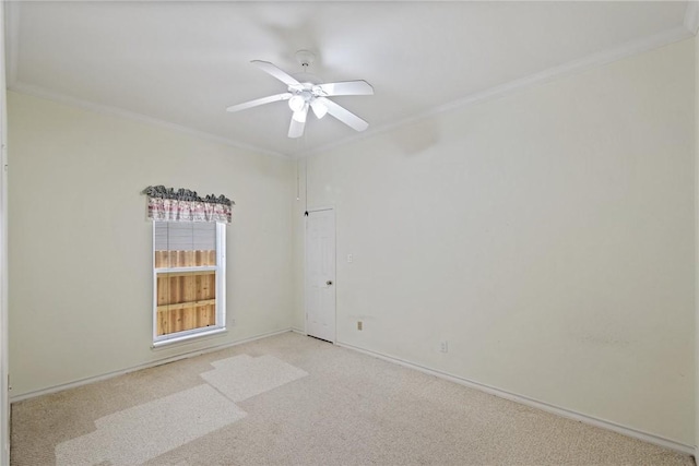 empty room featuring ornamental molding, light colored carpet, ceiling fan, and baseboards