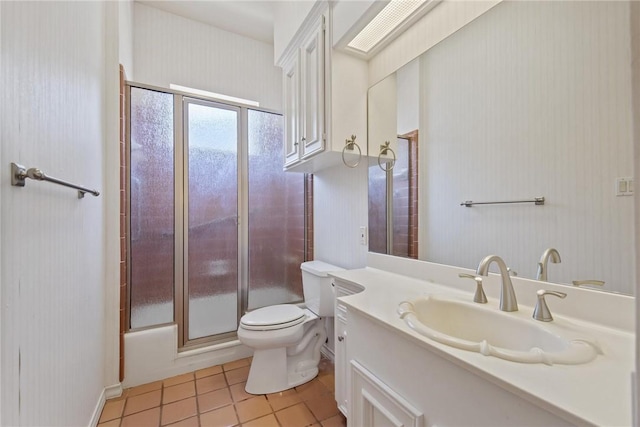 bathroom with a shower with shower door, toilet, tile patterned floors, and vanity