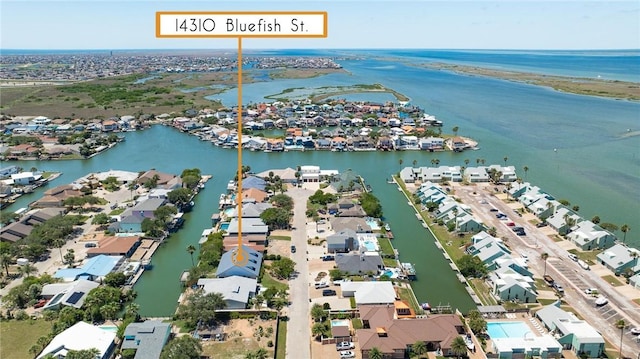 aerial view of property and surrounding area featuring a nearby body of water and nearby suburban area