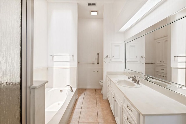 full bath with toilet, vanity, a bath, and tile patterned flooring