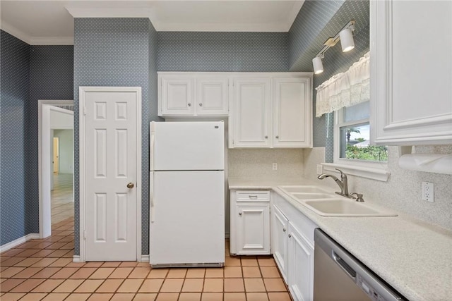 kitchen with freestanding refrigerator, dishwasher, a sink, crown molding, and white cabinetry