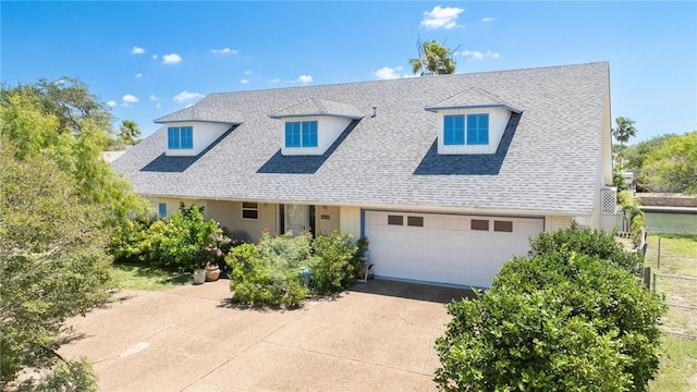 cape cod-style house featuring driveway and roof with shingles