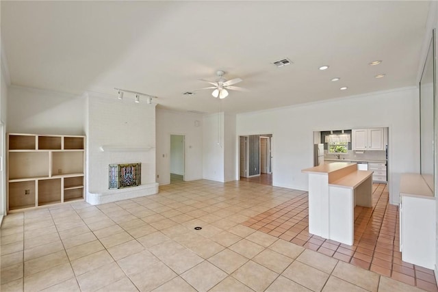 unfurnished living room with ornamental molding, a ceiling fan, light tile patterned floors, recessed lighting, and track lighting
