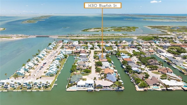 aerial view of property's location with a large body of water and nearby suburban area