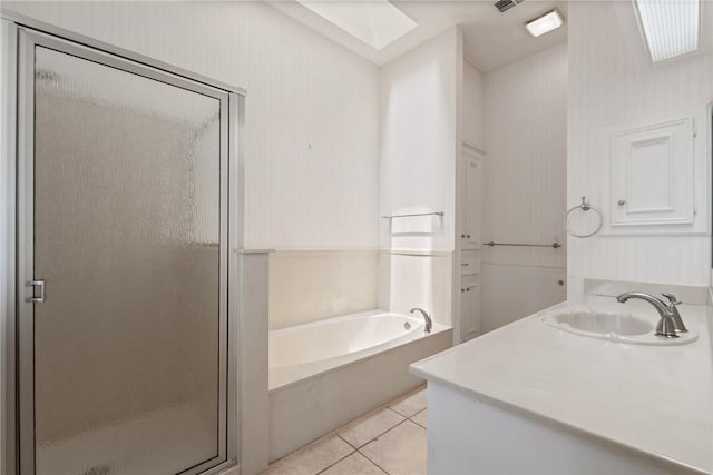 full bath featuring a shower stall, a bath, tile patterned flooring, vanity, and a skylight