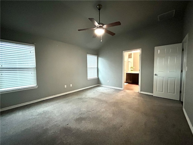 unfurnished bedroom with connected bathroom, vaulted ceiling, ceiling fan, and carpet floors