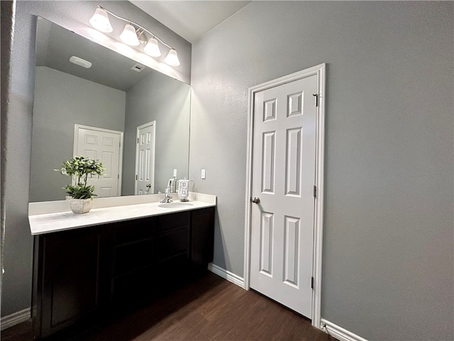 bathroom with vanity and hardwood / wood-style flooring