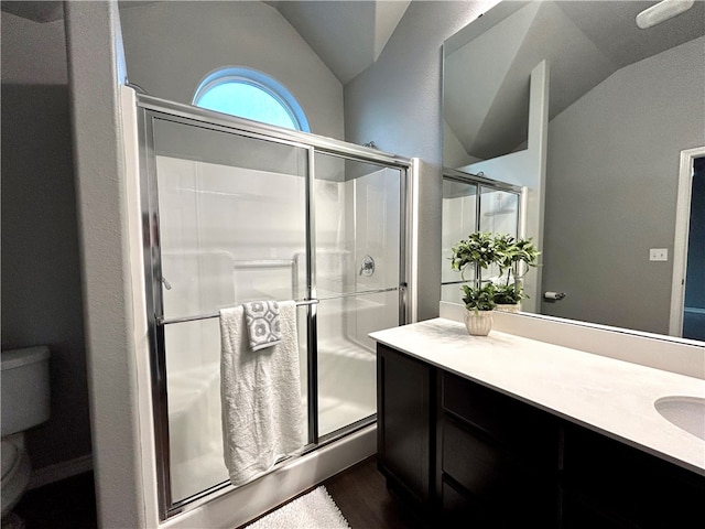 bathroom featuring vanity, an enclosed shower, hardwood / wood-style floors, toilet, and lofted ceiling