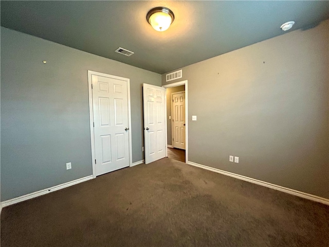 unfurnished bedroom featuring dark carpet