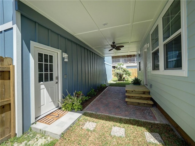 view of exterior entry featuring ceiling fan