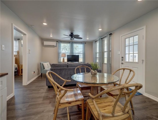 dining area with an AC wall unit, dark wood-type flooring, and ceiling fan