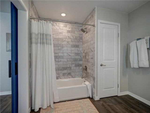 bathroom featuring hardwood / wood-style flooring and shower / bath combination with curtain