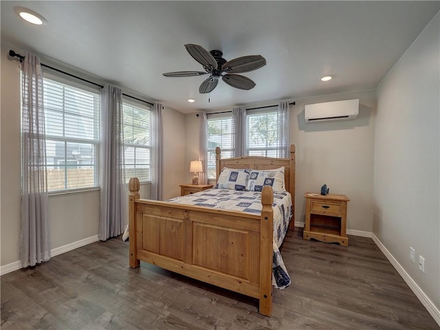 bedroom featuring ceiling fan, a wall mounted air conditioner, and dark hardwood / wood-style floors