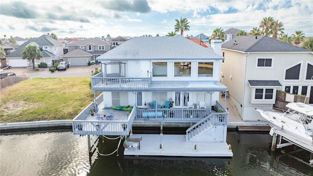 rear view of property featuring a yard and a water view