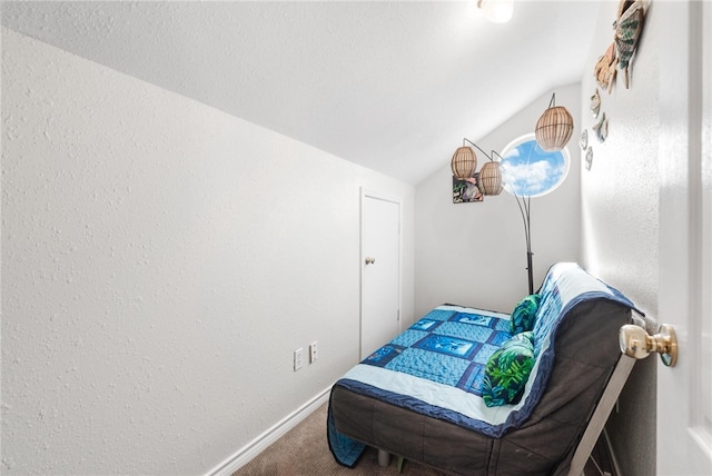 carpeted bedroom with vaulted ceiling