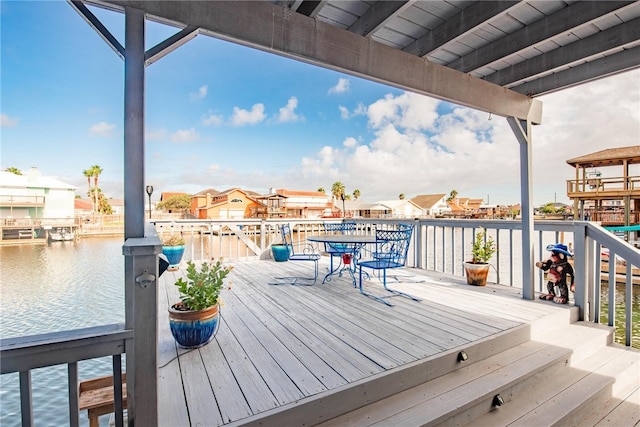 wooden deck featuring a water view