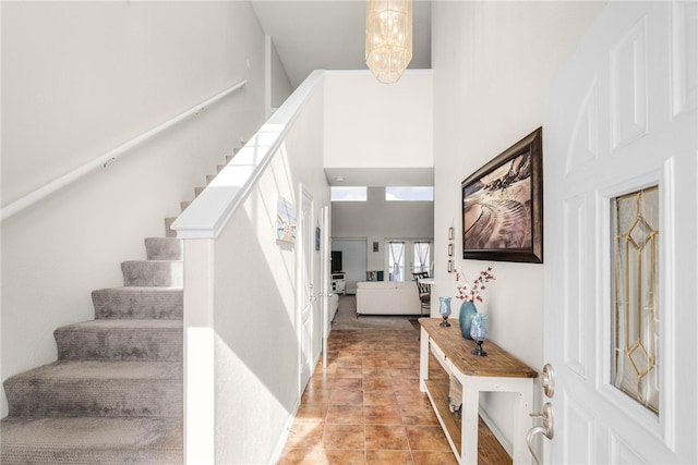 foyer with a high ceiling and a chandelier