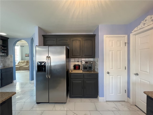 6317 Sir Jack St, Corpus Christi, TX 78414 - kitchen featuring stainless steel fridge, light marble finish floors, arched walkways, and tasteful backsplash