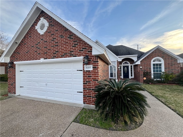 6317 Sir Jack St, Corpus Christi, TX 78414 - view of front of house featuring brick siding, driveway, and an attached garage