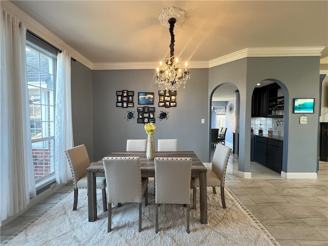 6317 Sir Jack St, Corpus Christi, TX 78414 - dining area featuring a chandelier, ornamental molding, and arched walkways
