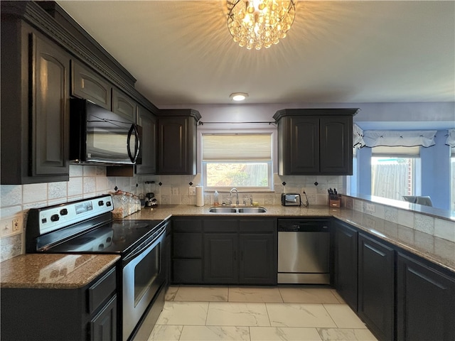 6317 Sir Jack St, Corpus Christi, TX 78414 - kitchen with appliances with stainless steel finishes, light marble finish flooring, backsplash, and dark stone counters
