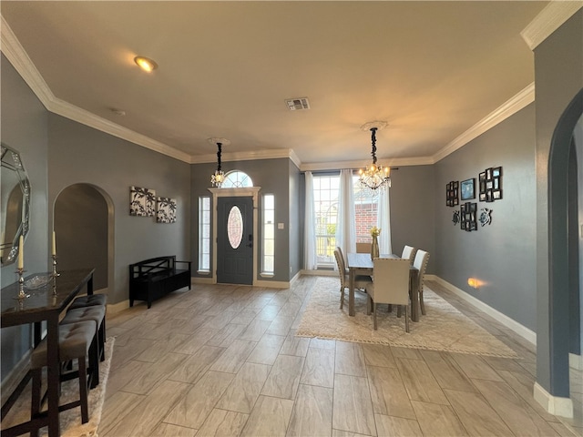 6317 Sir Jack St, Corpus Christi, TX 78414 - dining space featuring arched walkways, a chandelier, crown molding, and wood finish floors